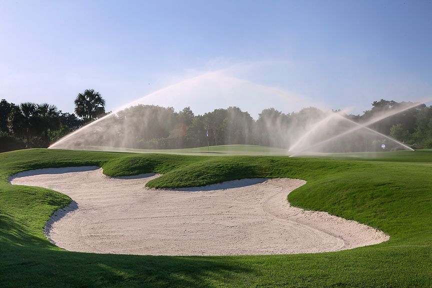 sprinklers watering a golf course