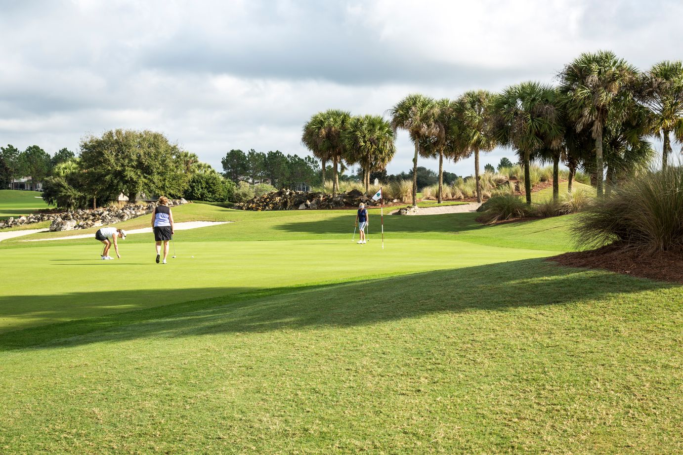 Three women playing golf