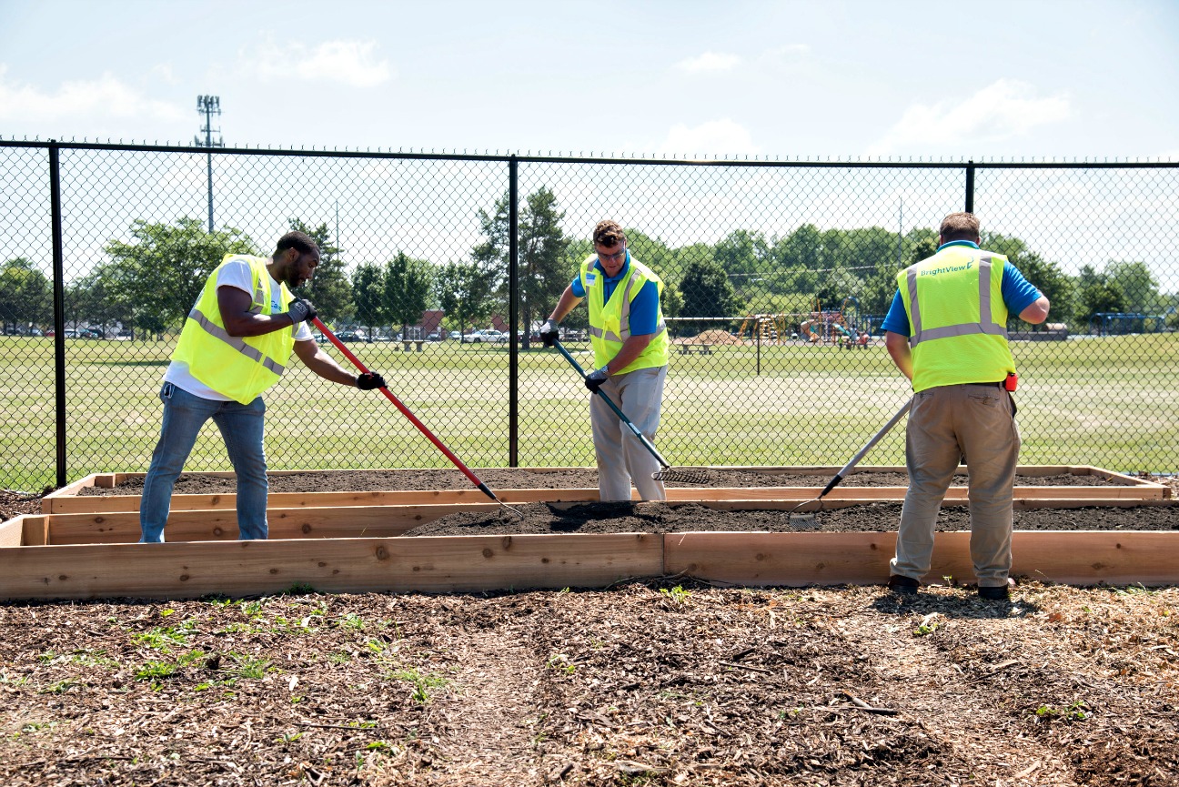 BrightView employees building planter beds for St. Stephen's community garden program, Program Aquastar, and to grow produce for their food nutrition center. 